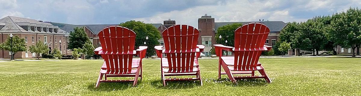 red adirondack chairs overlook the upper quad